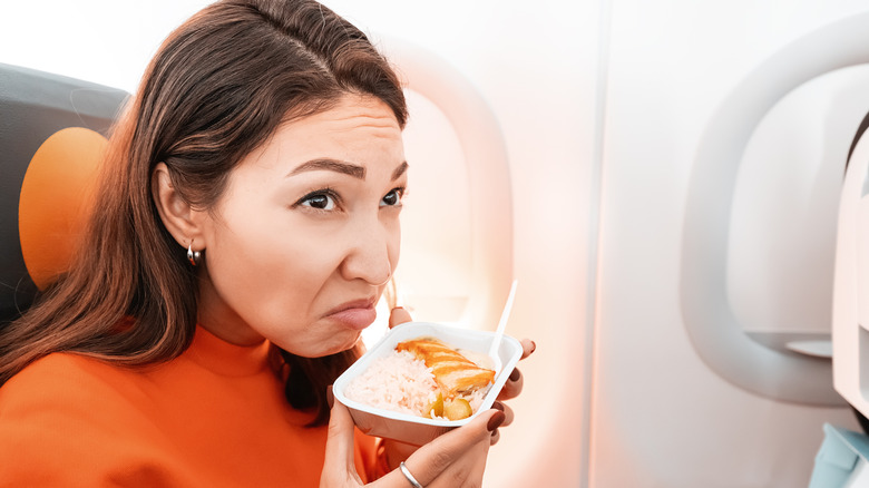 Woman smelling something on plane