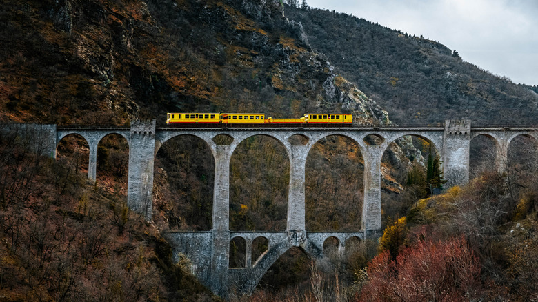 A yellow train on bridge