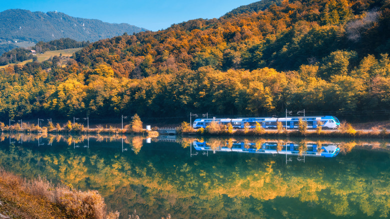 Train by lake and mountains