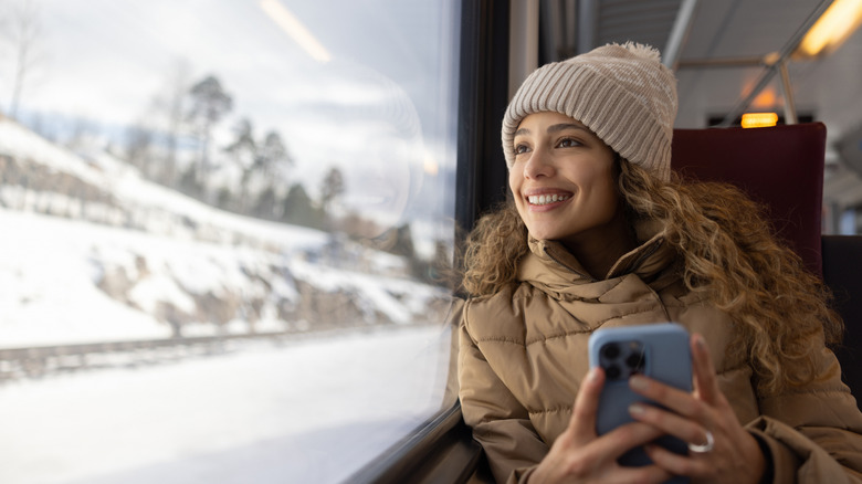 Woman looking out train window