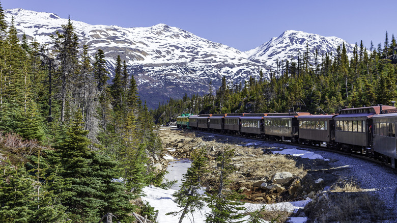 Train curving through snowy mountains