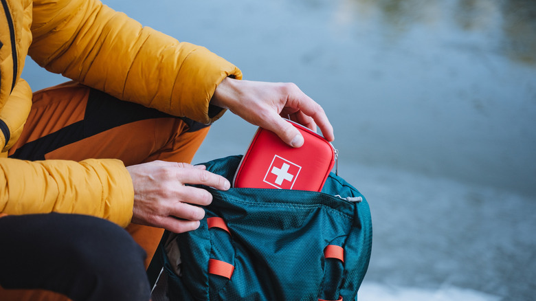 Person packing first aid kit