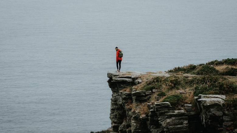 Person standing on cliff edge