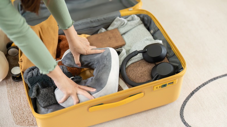 Woman packing a carry-on