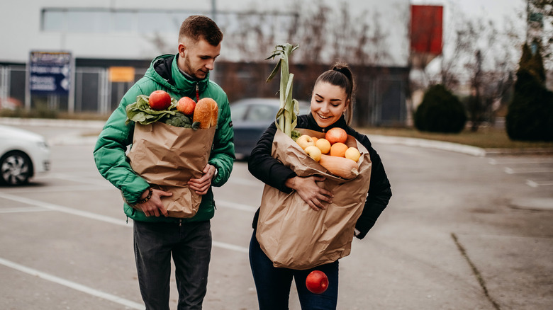 Couple carrying bags