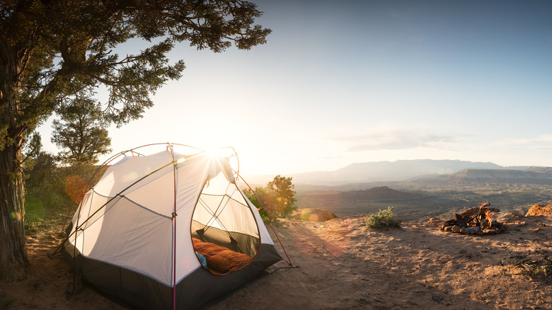 tent and campfire on a cliff