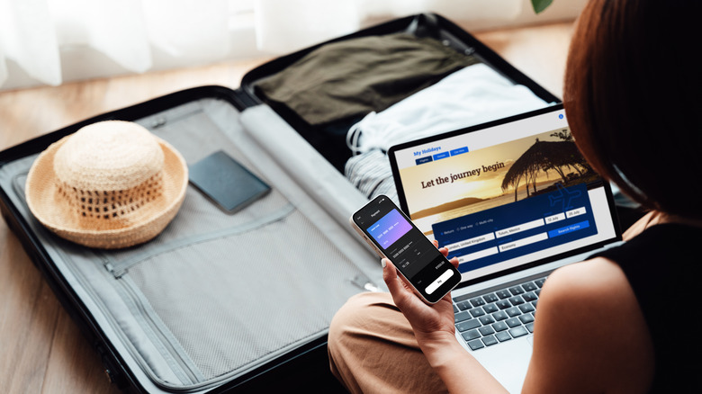 Woman booking flight on computer