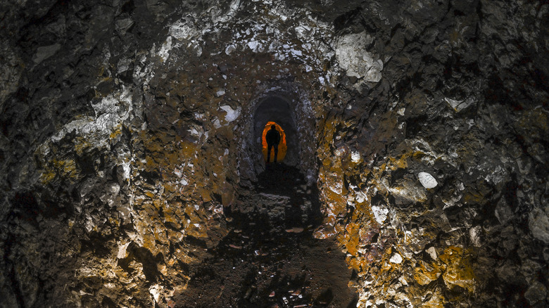 Man exploring an underground labyrinth