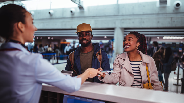 Couple at airline check-in desk