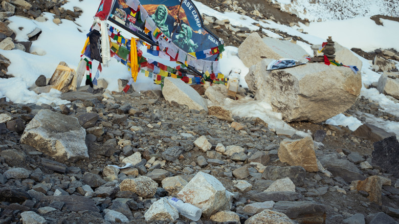 Trash on the ground near the Everest Base Camp sign