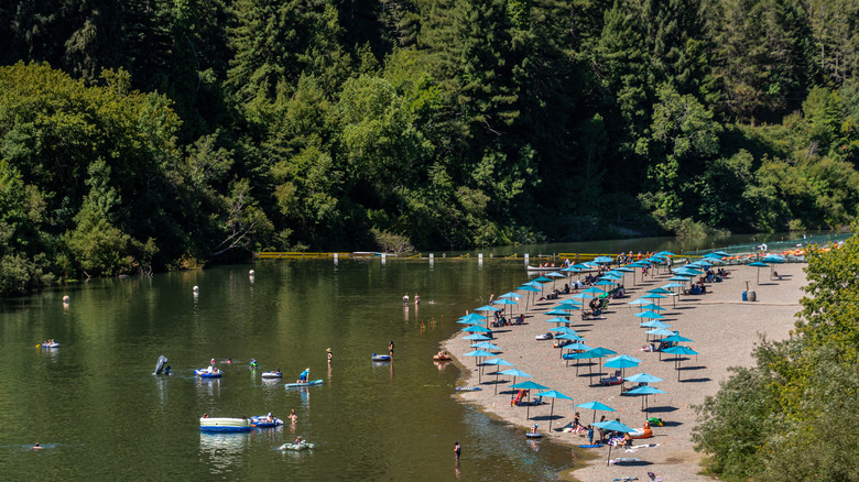 People enjoying a lakeside beach