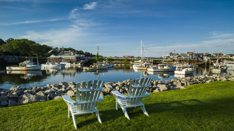 Two chairs in front of boats 