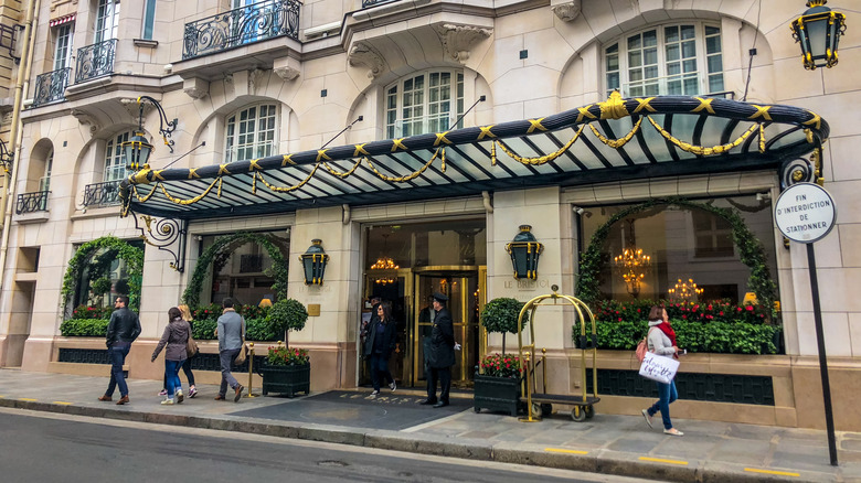 People walking outside Le Bristol Hotel in Paris