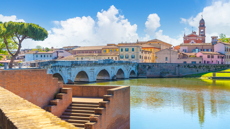 Tiberio Bridge with houses and church in background, Rimini