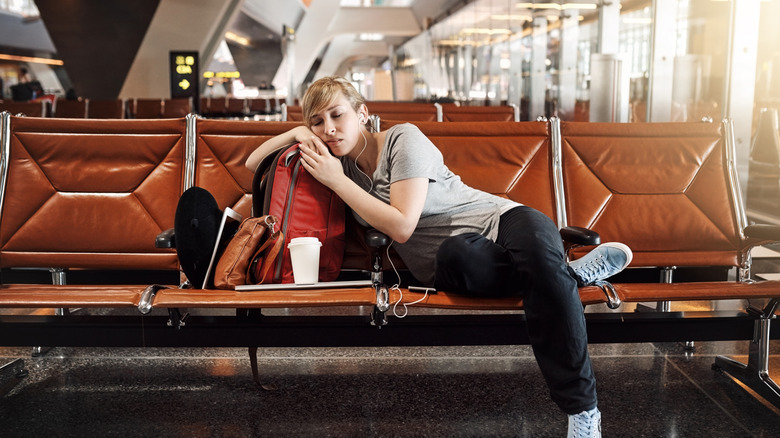 A passenger sleeping in an airport