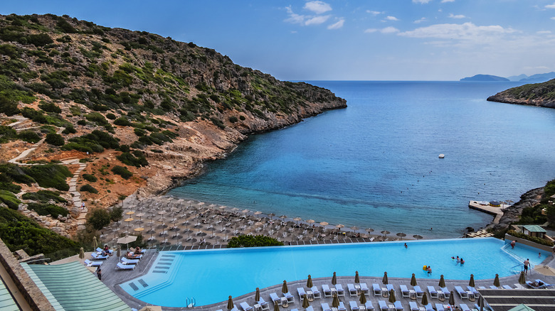 An outdoor pool overlooking the private beach at Daios Cove Resort in Crete