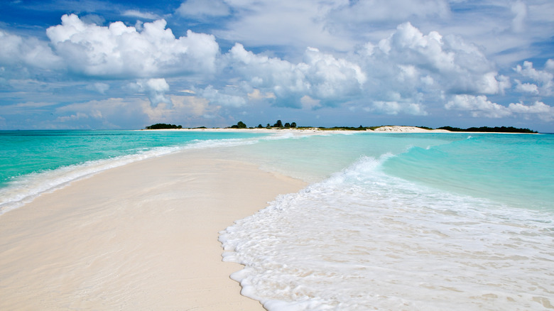 white sandbar in turquoise ocean