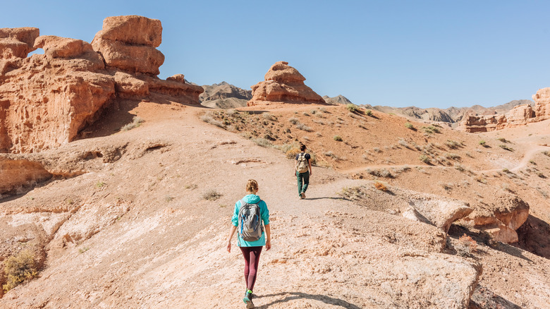 Tourists walking through the desert land of Kazakhstan