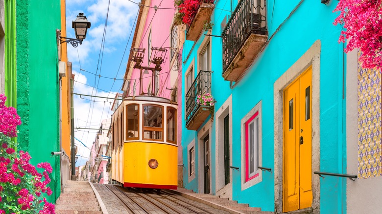 Tram going through a colorful street in Portugal