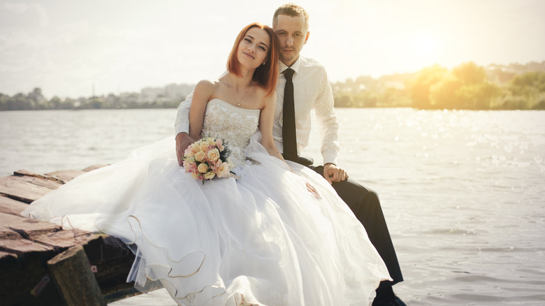 Newlyweds on dock in Maine