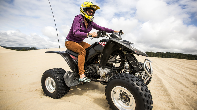 woman riding ATV on Oregon sand dunes