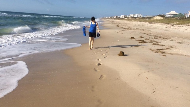 A woman walks on the beach