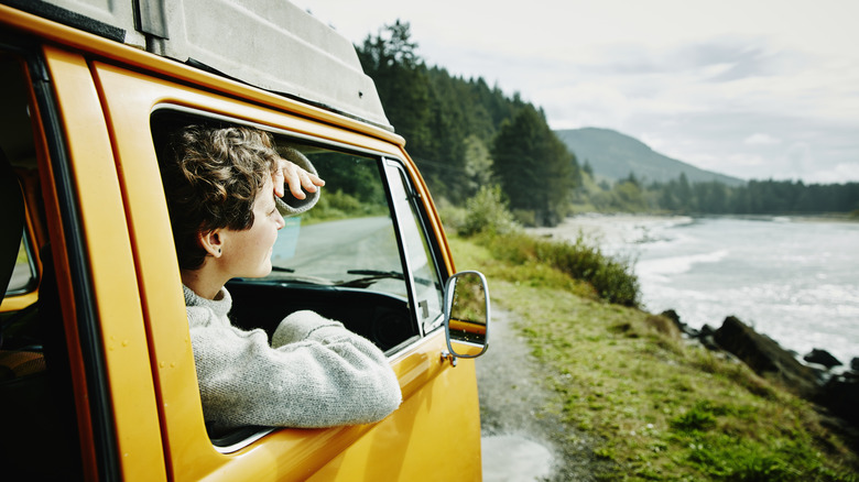 Woman looking out van window at scenery