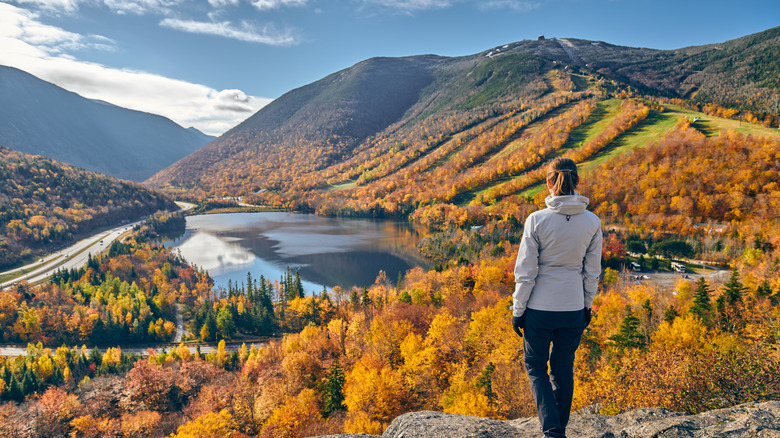 woman hiking fall foliage mountains