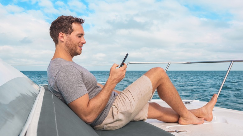 Man using his phone in a cruise