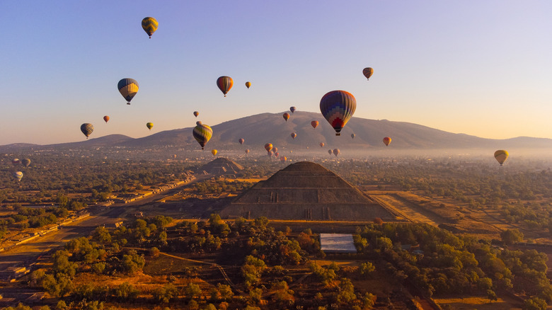 Hot air balloons over Teotihuacan pyramid at sunrise