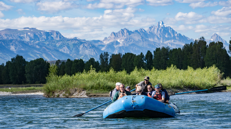 A group of tourists rafting through the Snake River