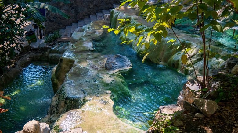 Water cascades over smooth limestone steps at the Grutas de Tolantongo, Mexico