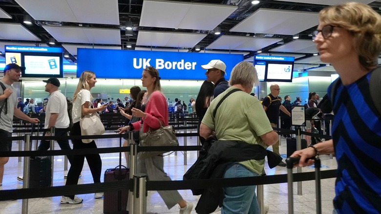 Line of travelers at the UK border in Heathrow Airport