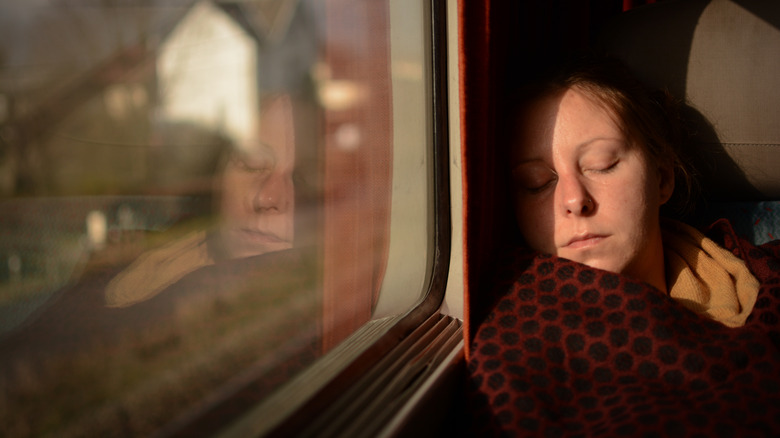 Person sleeping on a train