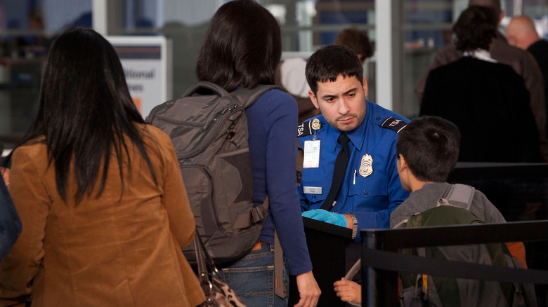 TSA agent screening passenger