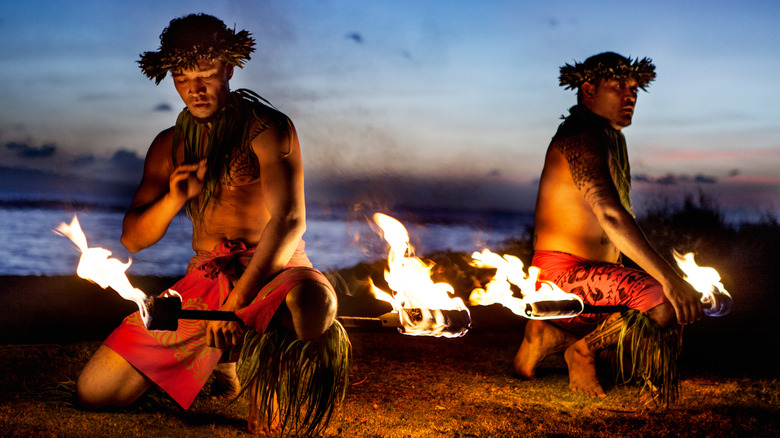 Men dancing with fire at Hawaiian luau