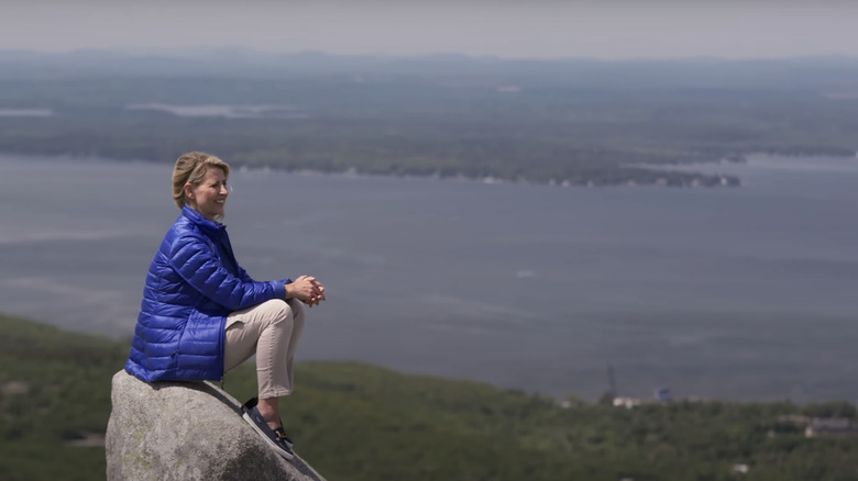 Samantha Brown sitting on a rock in Maine