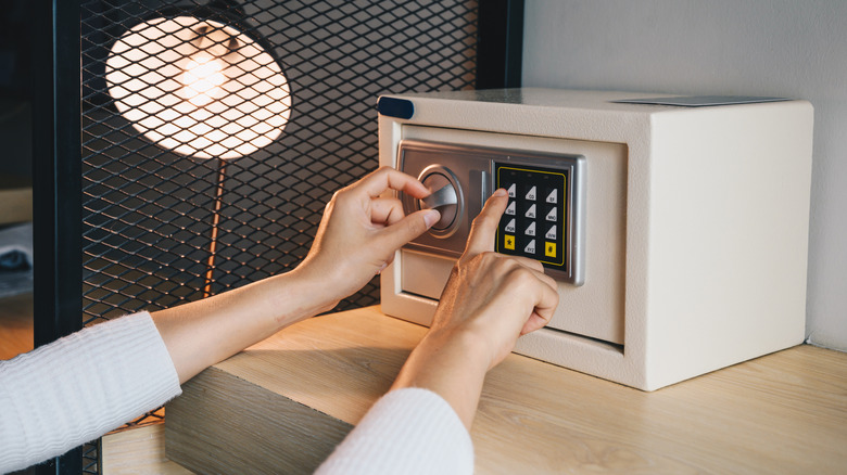 A person setting passcode on a safe