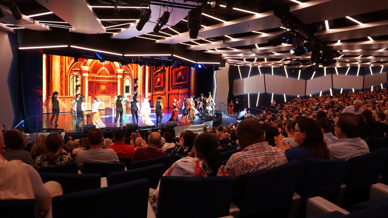 People watching a performance in a theater on board a cruise ship