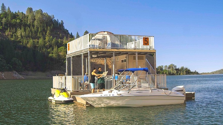 Floating campsite with two levels and boat.