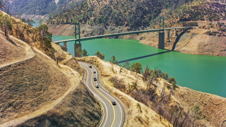 Dry canyon and green river with a bridge