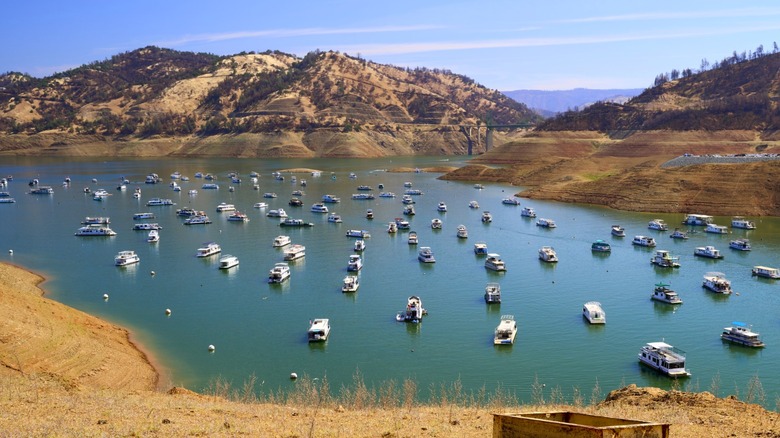 Boats anchored in calm lake bay.