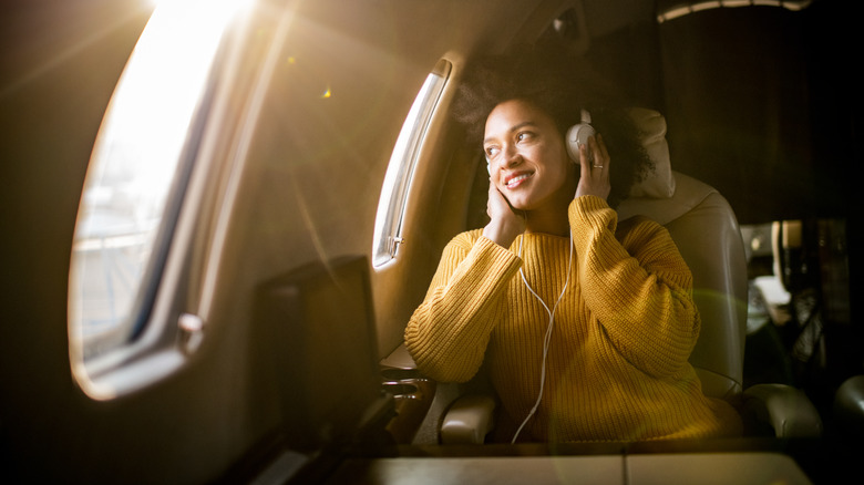 Woman using headphones on a flight