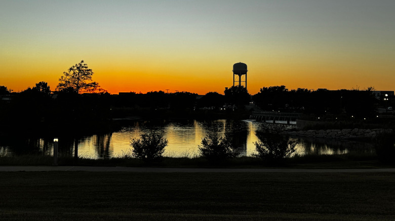 Buda, Texas, water tower and trees silhouetted at sunset