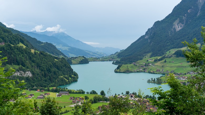 Switzerland's Lake Lungern surrounded by green mountains and a quaint village