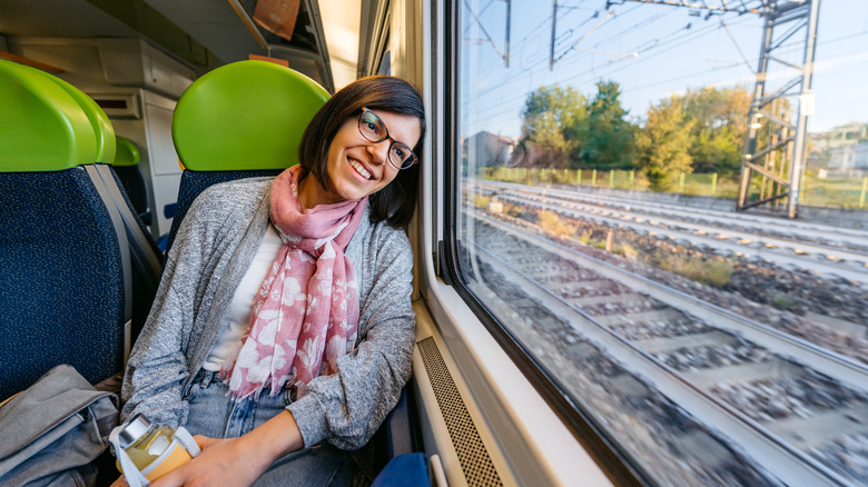 Traveler looking out the window of a train in Milan, Italy