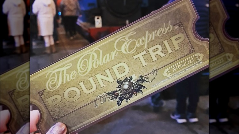 Someone holding a golden round-trip ticket to the Polar Express