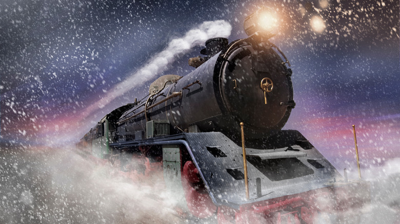 A steam train speeding through the snow