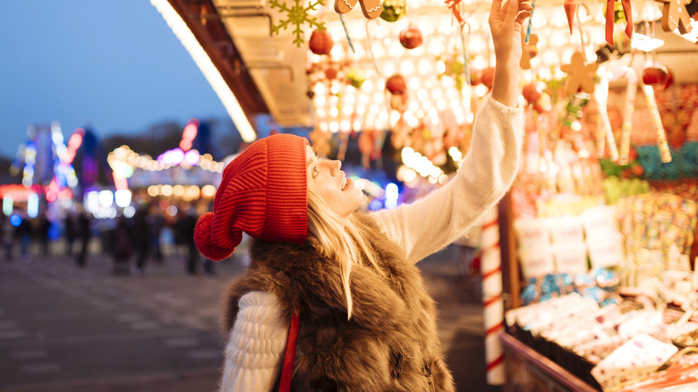 Woman looking at Christmas decorations at a market in London