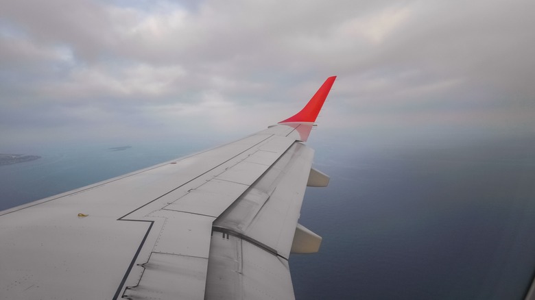 airplane wing dark clouds